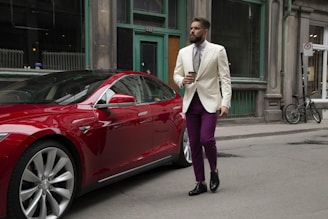 person standing near red vehicle