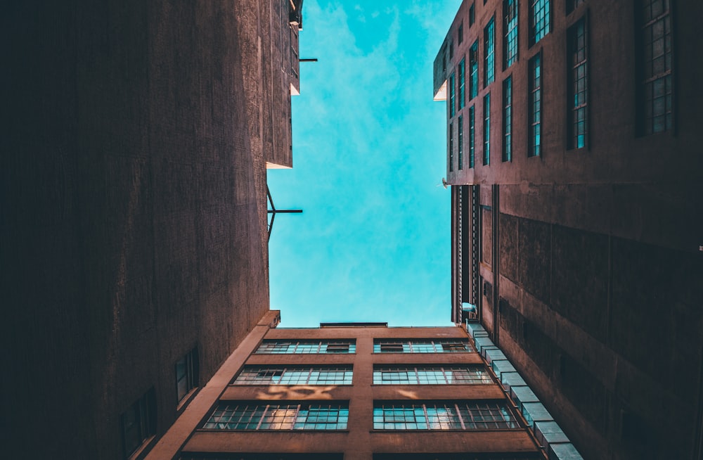 low-angle photography of brown concrete building