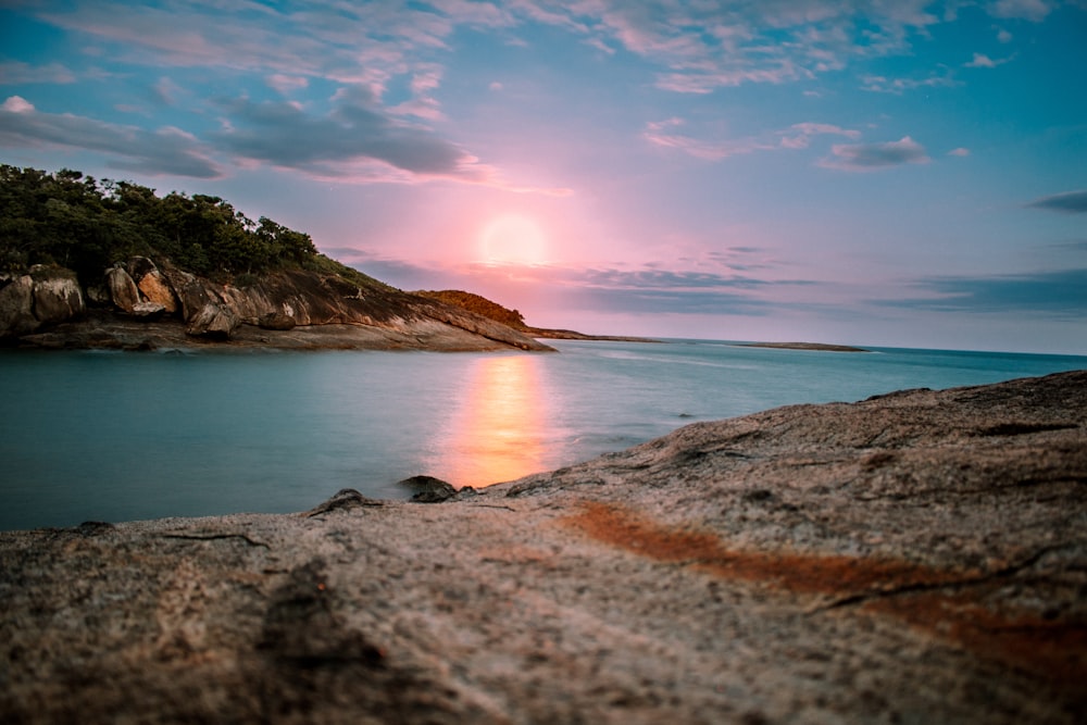 body of water during sunset