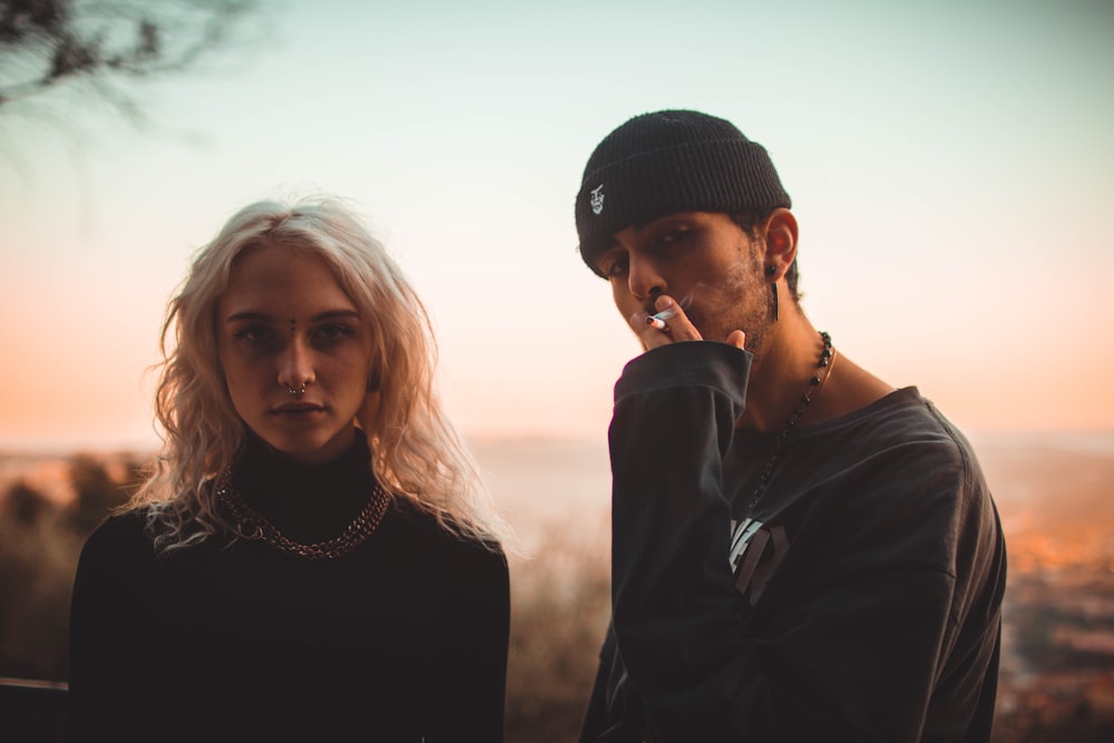 man and woman standing outdoors during daytime