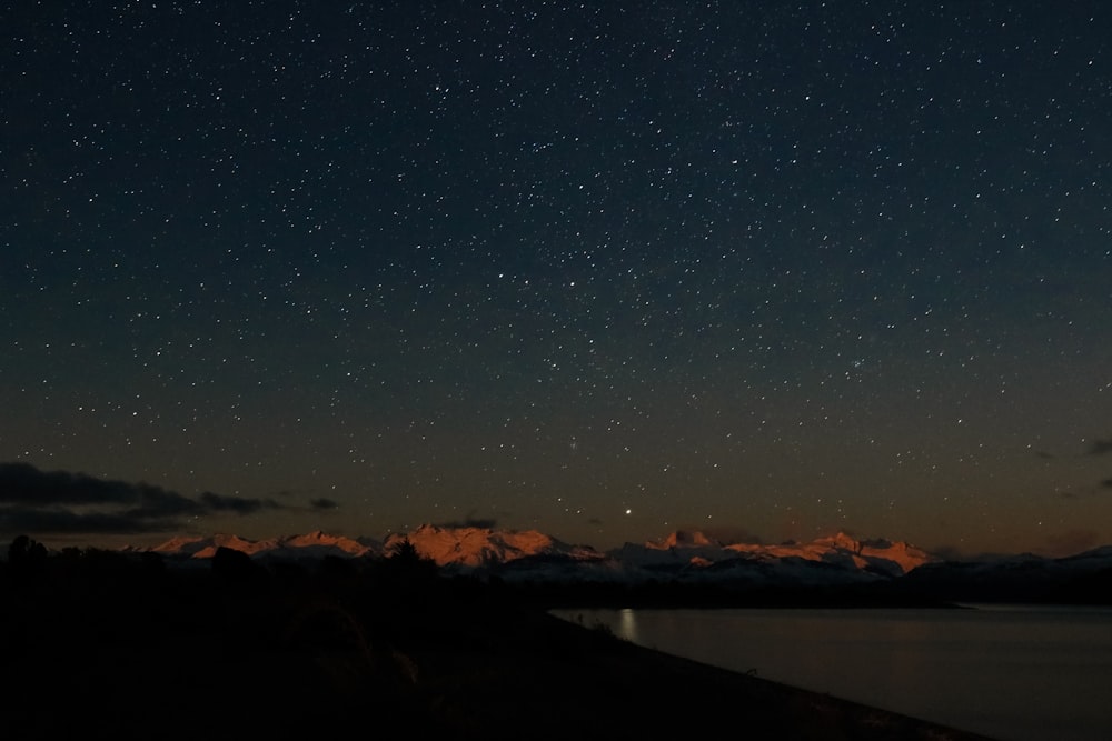 landscape photography of clear sky full of stars over mountains during night