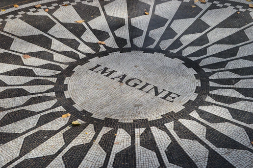 a black and white mosaic with the word imagine on it