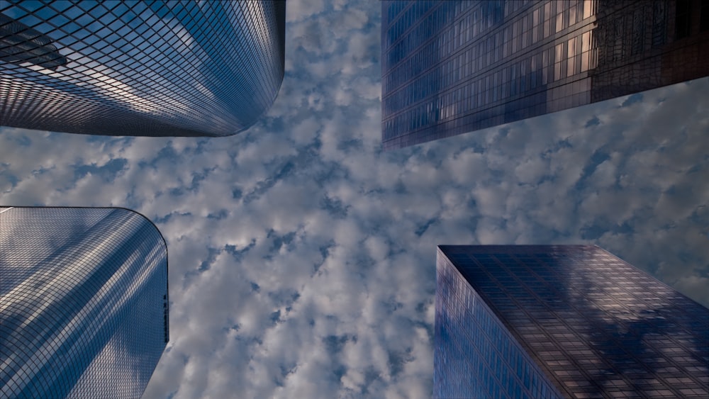 a group of tall buildings in a cloudy sky