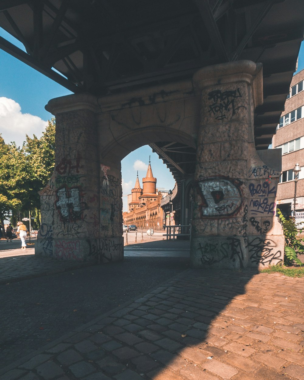 brown concrete bridge pillars beside trees