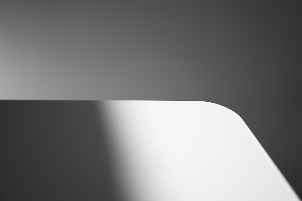 a close up of a white table with a black background