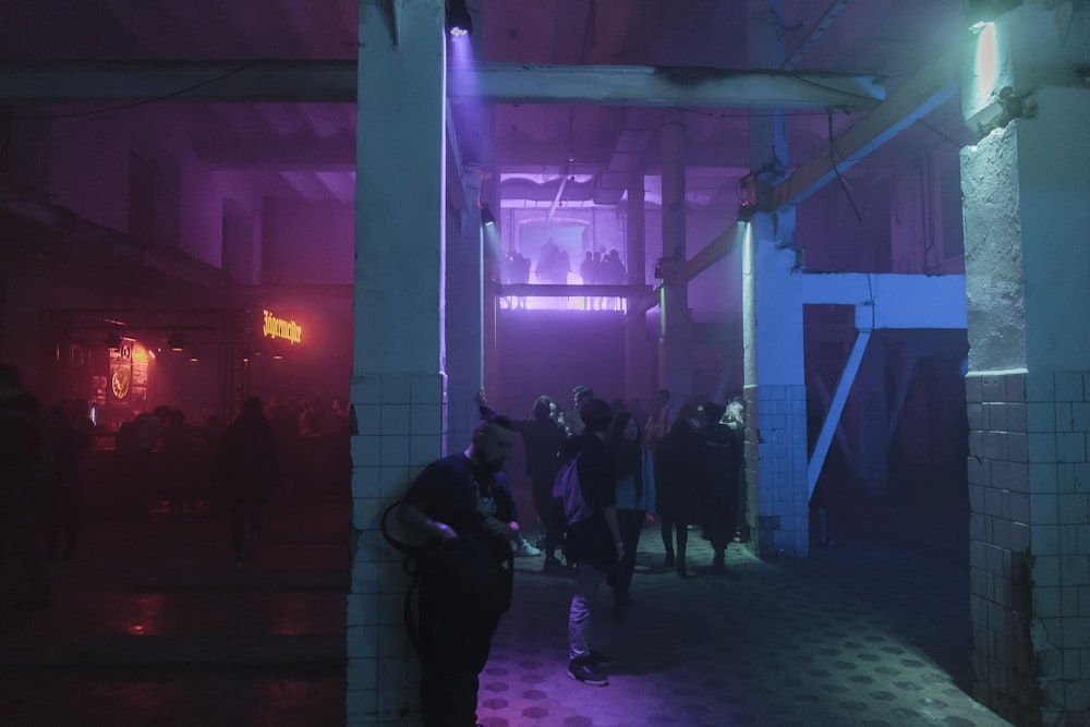 people standing on floor in concrete building interior