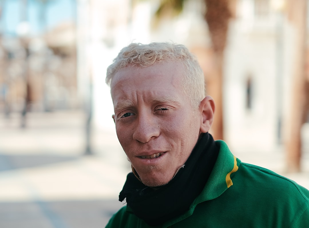 man in green top smiling