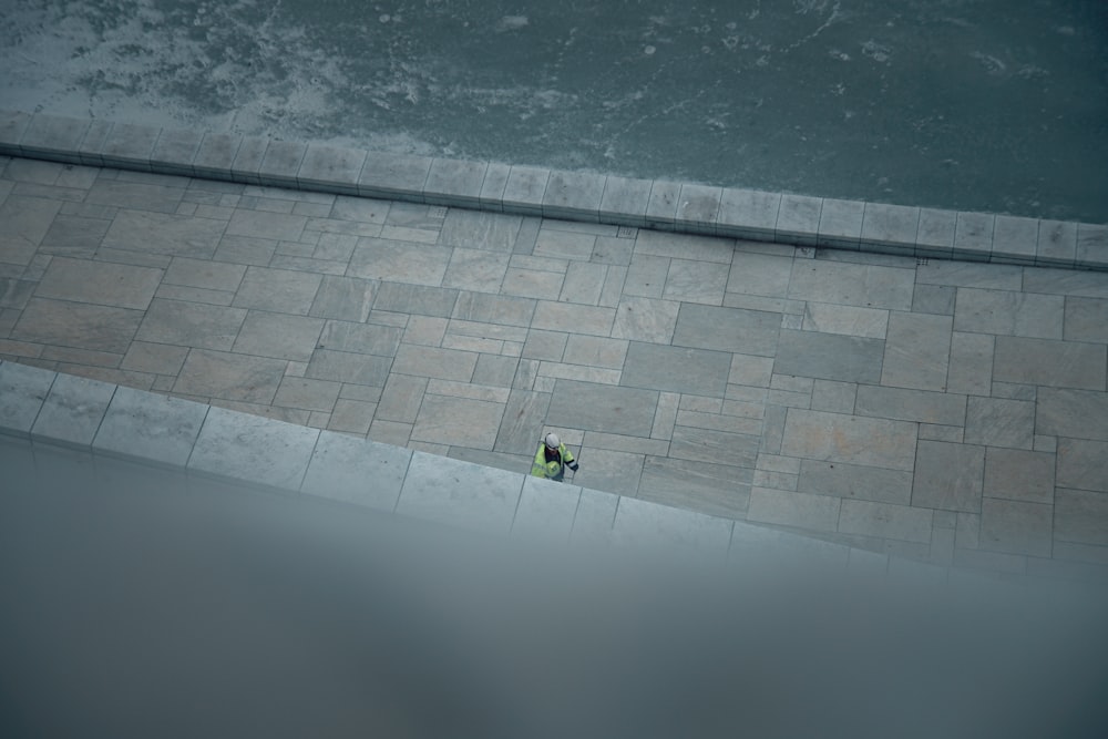 a person walking down a street next to a sidewalk