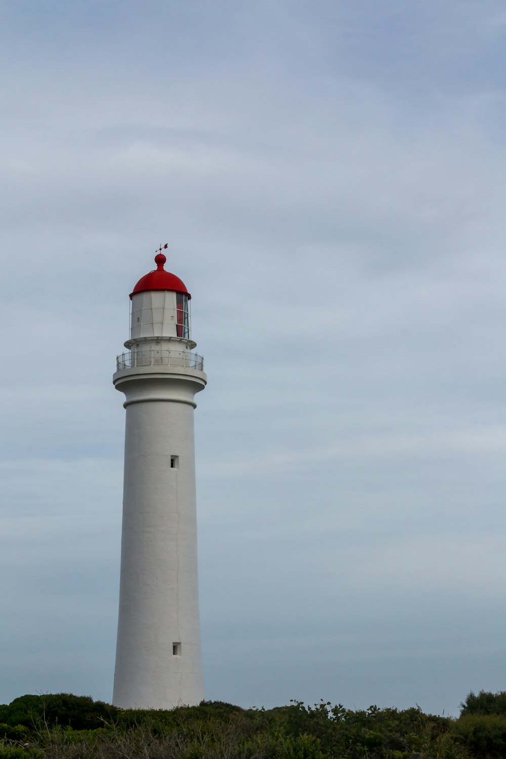 white lighthouse under white sky