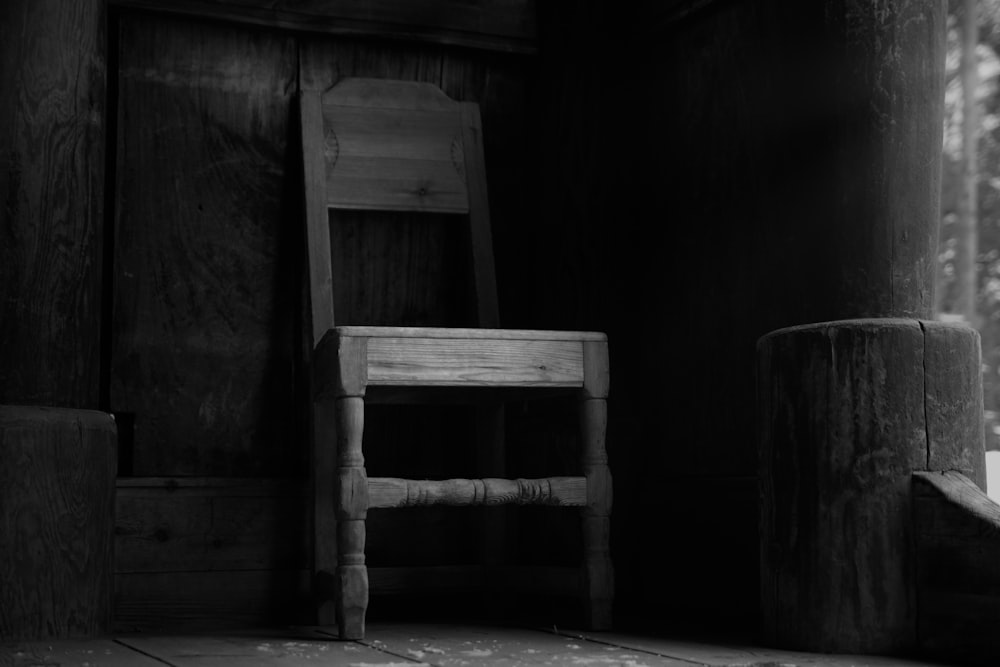 grayscale photography of wooden chain on porch