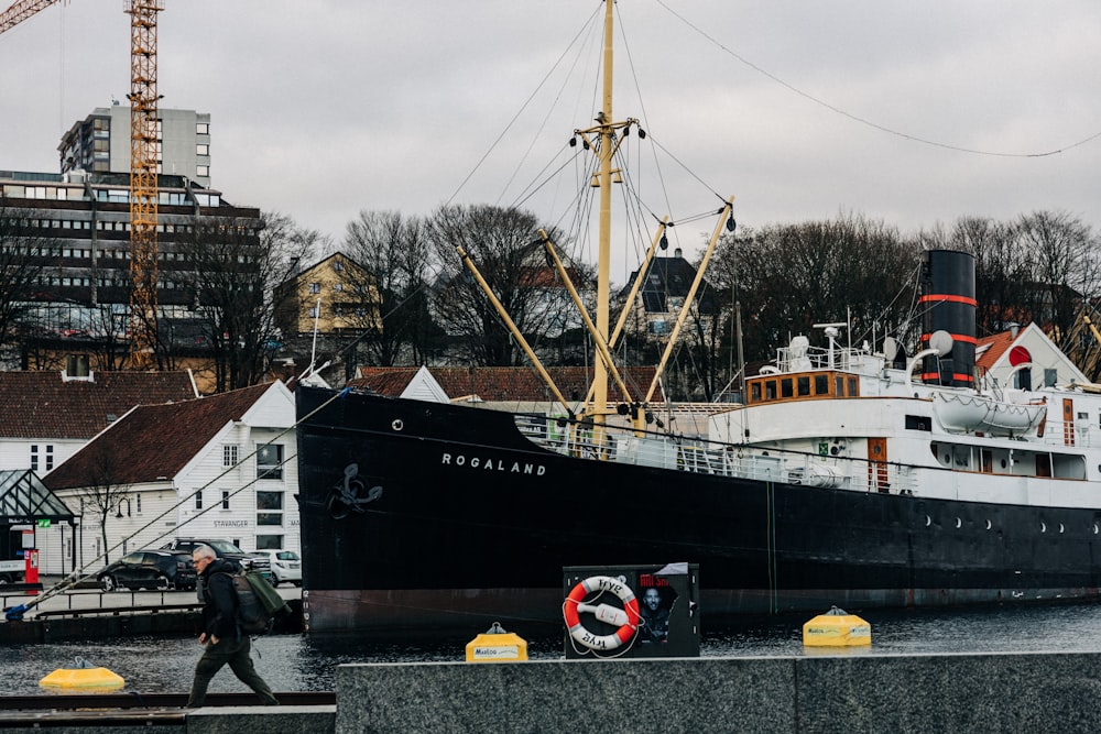 black and white Rocaland fishing vessel on dock during daytime