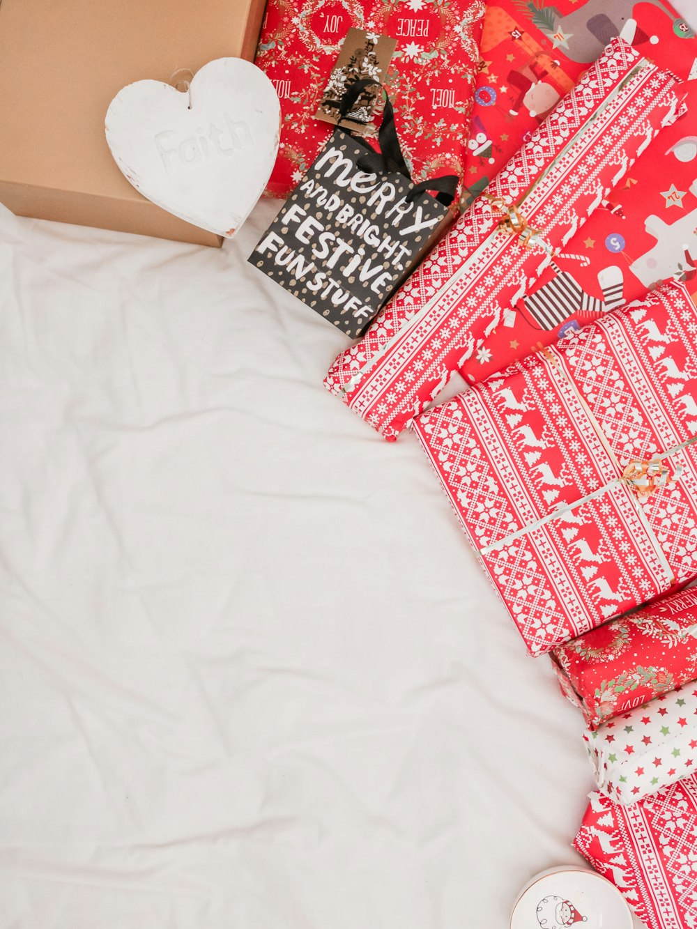 red and black packed presents on white textile