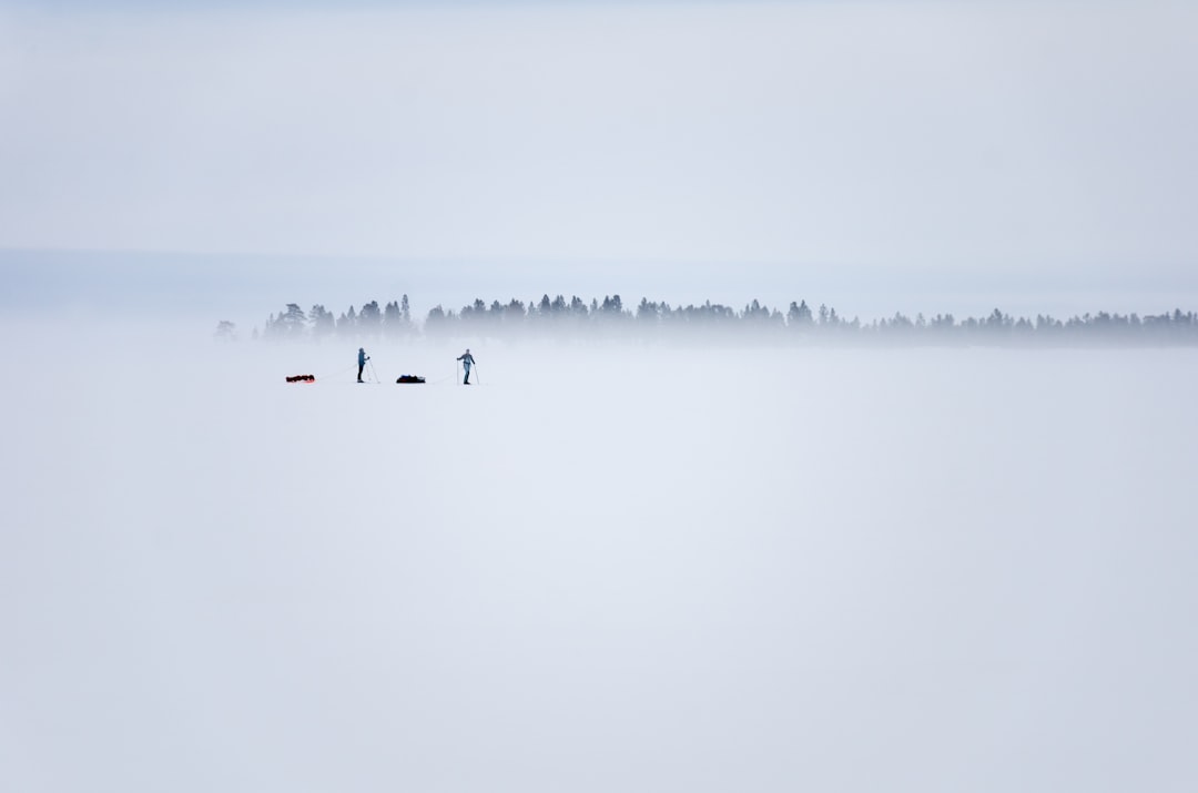 two persons standing on ice field
