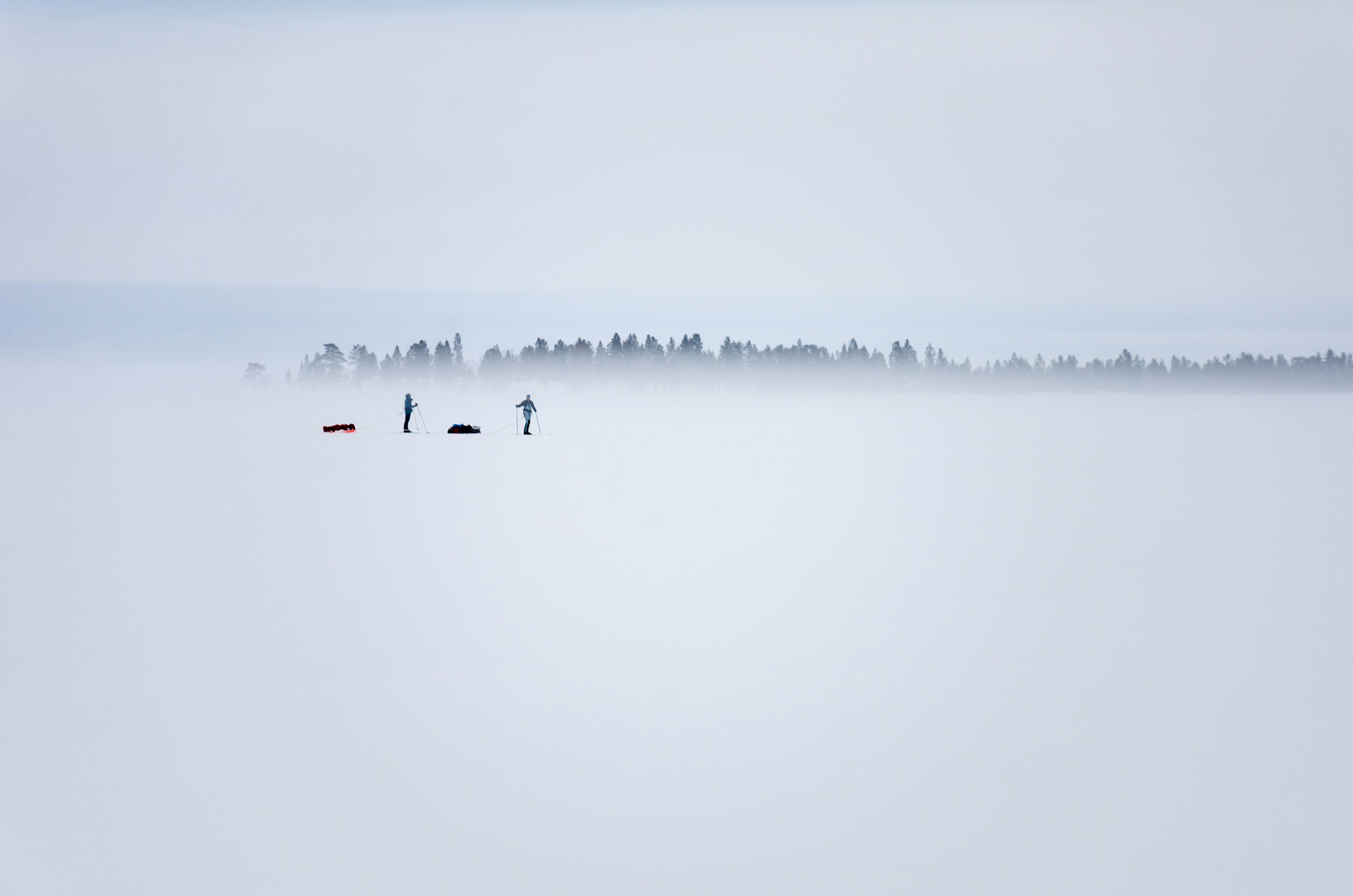 two persons standing on ice field