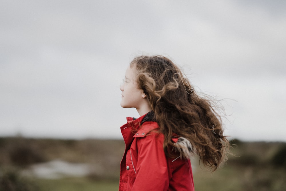 selective focus photography of girl wearing red jacket