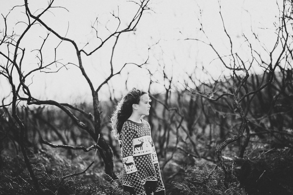 person standing beside trees