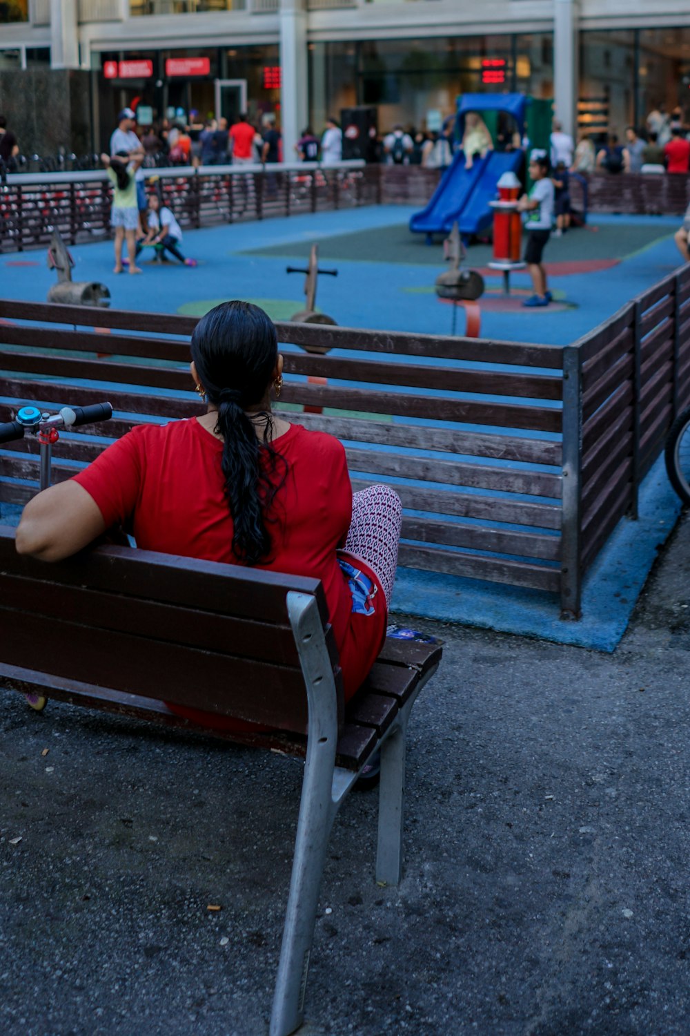 woman in red top sitting on bench