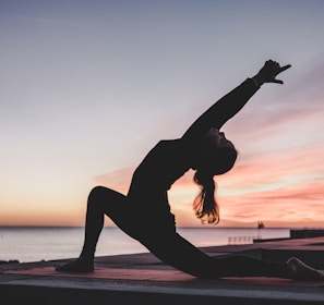 silhouette photography of woman doing yoga