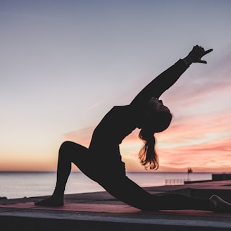 silhouette photography of woman doing yoga