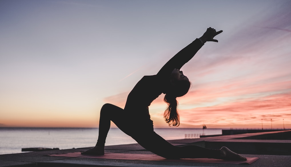 silhouette photography of woman doing yoga