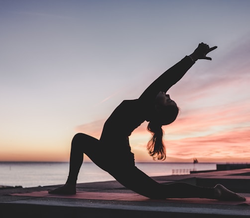 silhouette photography of woman doing yoga