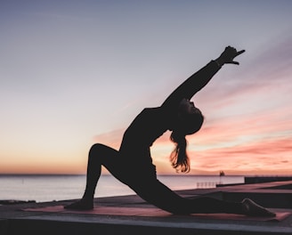 silhouette photography of woman doing yoga