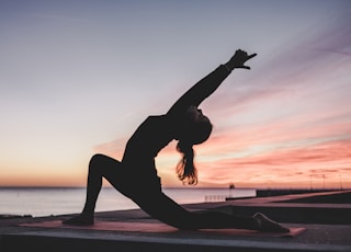 silhouette photography of woman doing yoga