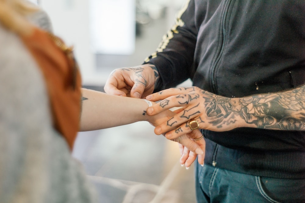 man holding the hand of the woman