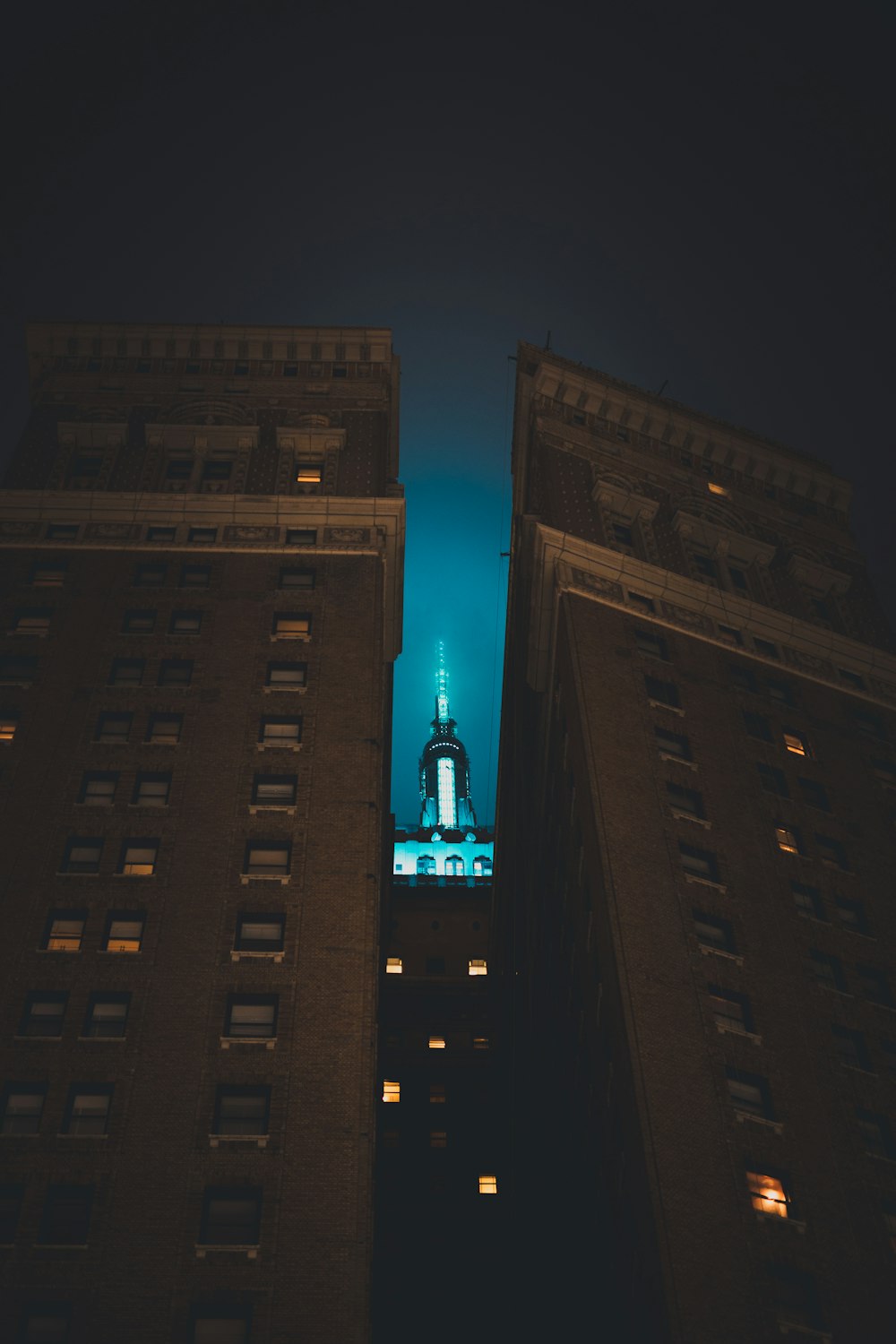 lighted tower between buildings