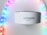 A white Amazon device, possibly a smart speaker, is positioned in the center with a soft focus on colorful LED strip lights forming an arch around it. The LED lights display a gradient of colors including purple, pink, blue, and green.