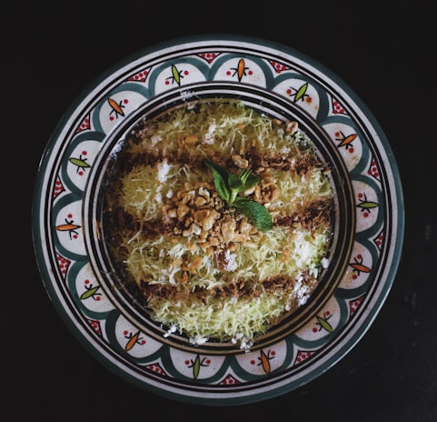 Close-up of a beautifully decorated traditional Middle Eastern dessert from Besbousa Confectionery.
