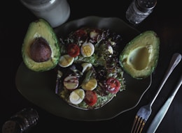 sliced avocado fruit and salad with eggs