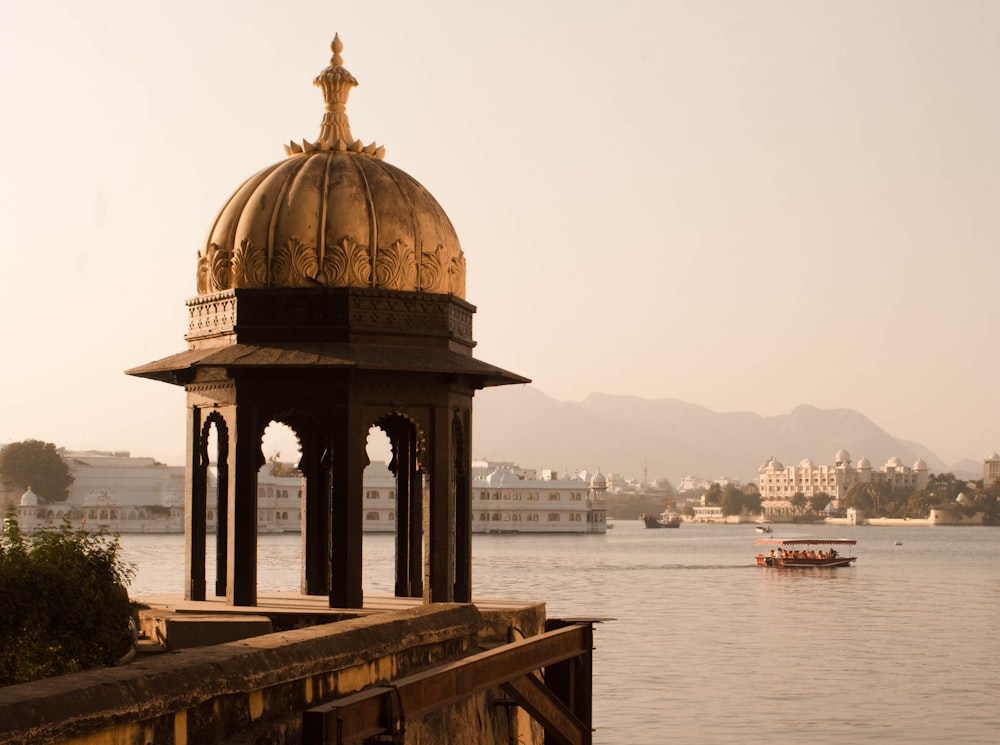 brown dome gazebo in front of body of water