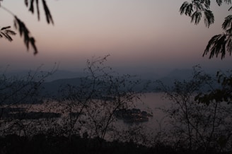 A serene landscape shot taken by marque dewinter, showcasing the interplay of light and shadow at dusk