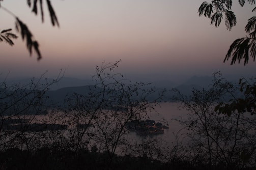 A serene landscape photo at dusk with muted charcoal and soft white hues