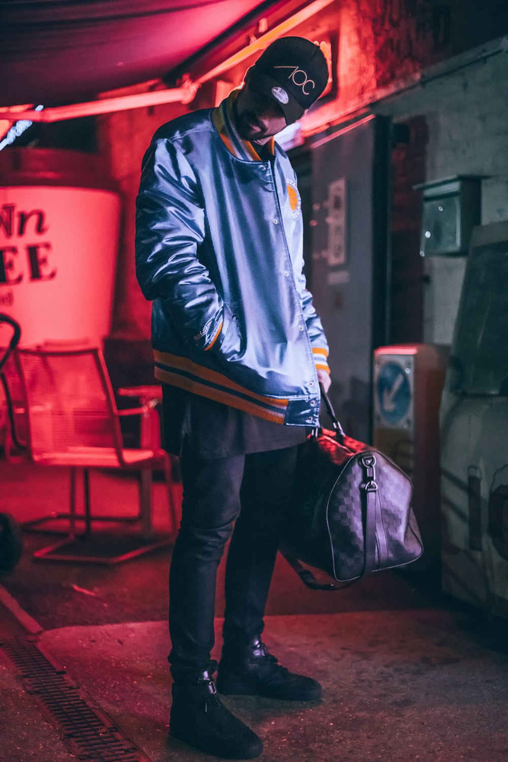 man carrying bag standing inside