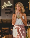 woman drinking mint juice standing beside building