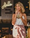woman drinking mint juice standing beside building