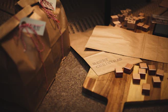 A cozy scene featuring a handwritten gift tag resting on a stack of charmingly wrapped presents.