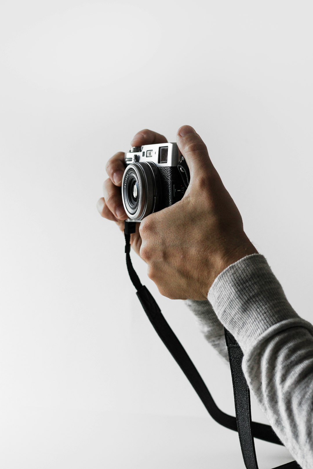 person holding gray and black camera