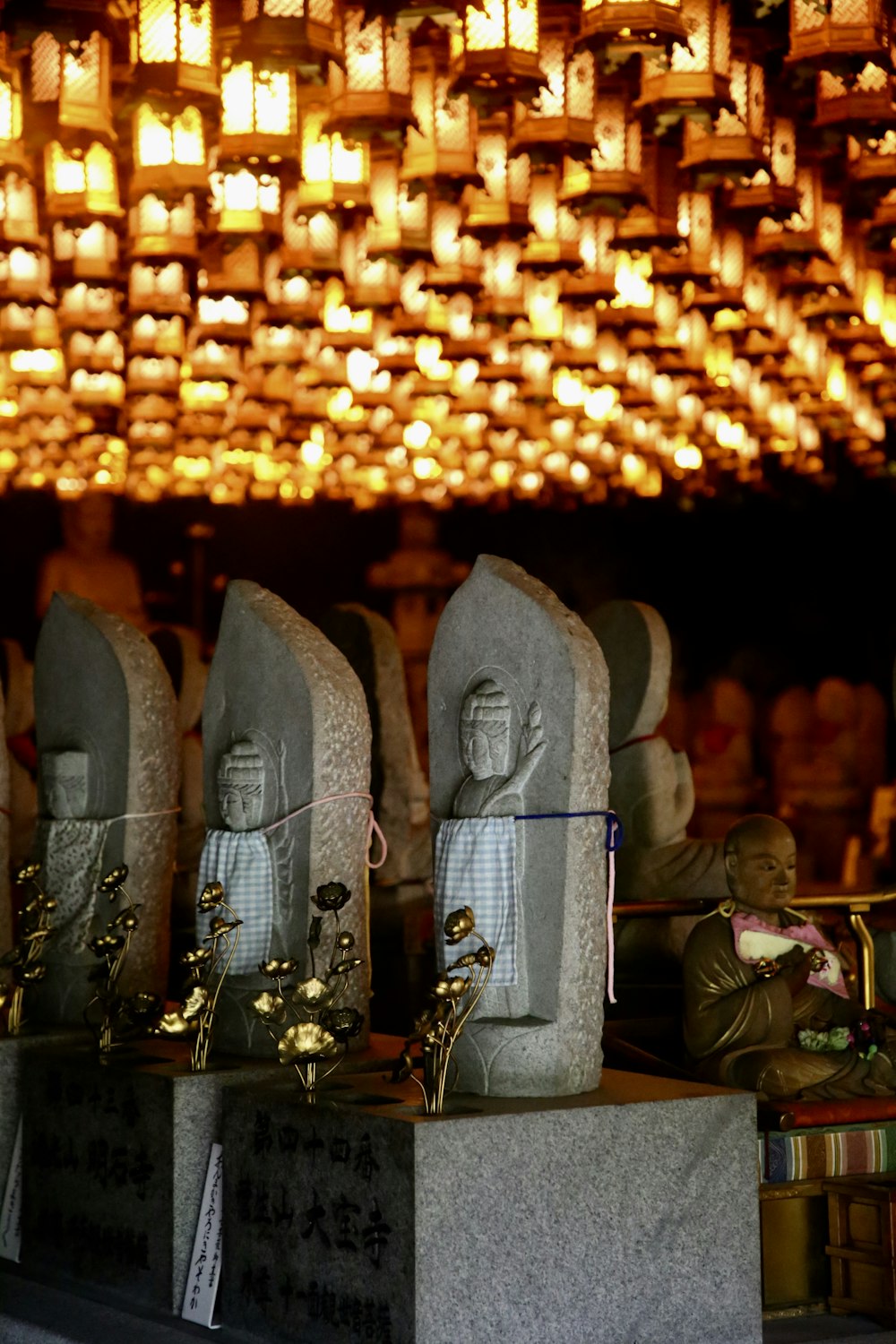 tombstone beside lanterns
