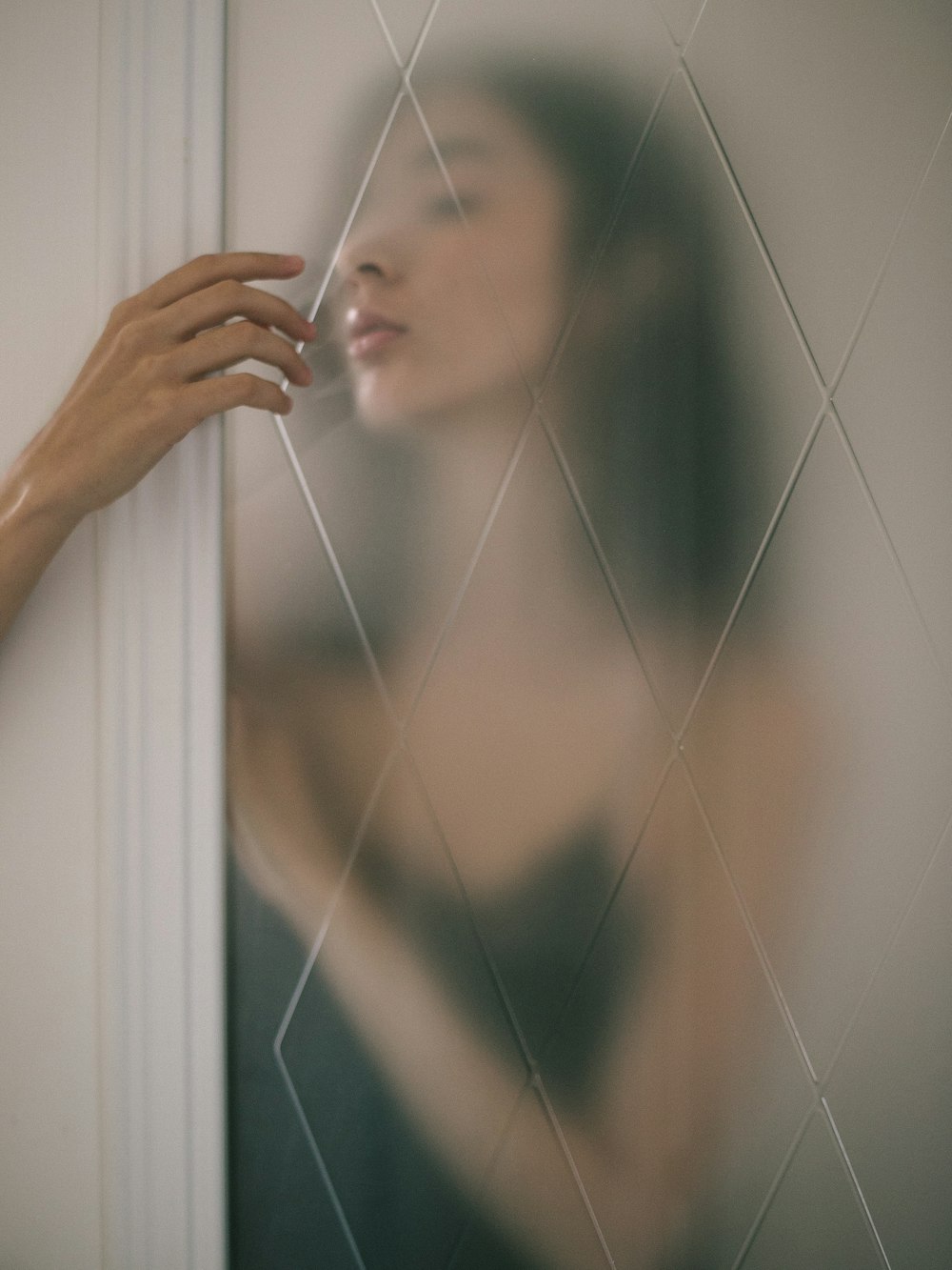 woman behind of panel glass door