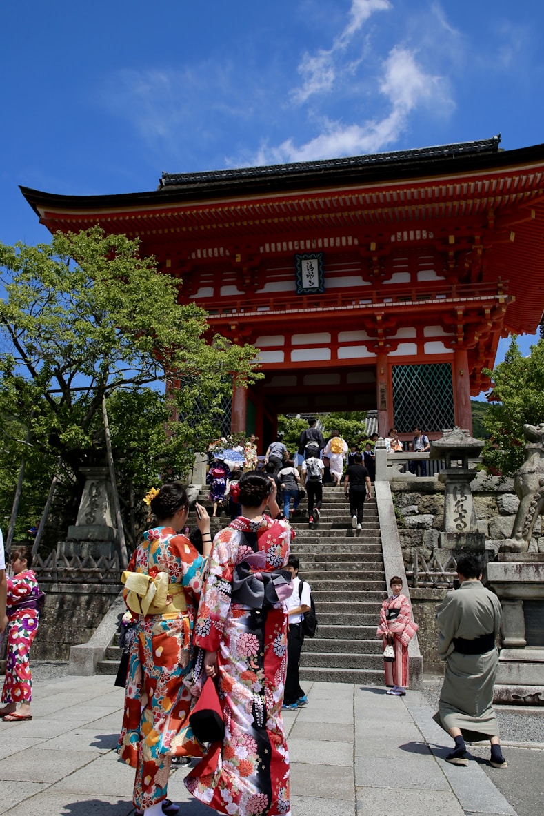 group of people walking outside red temple