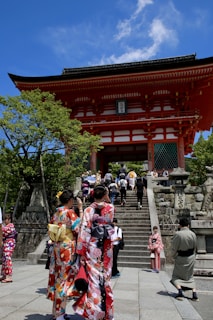 group of people walking outside red temple