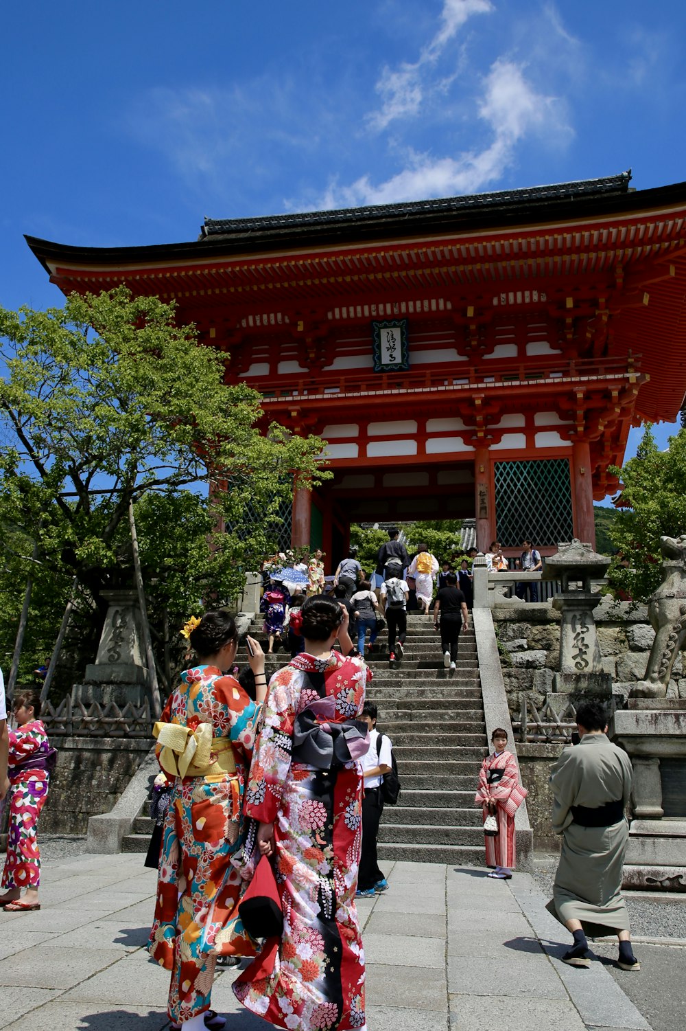 group of people walking outside red temple