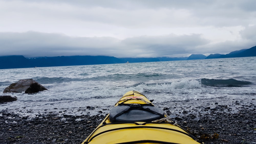 yellow kayak on the seashore