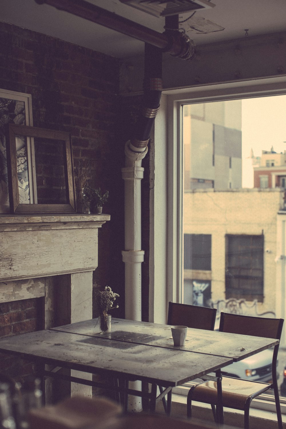 brown and gray wooden dining set near mantelpiece