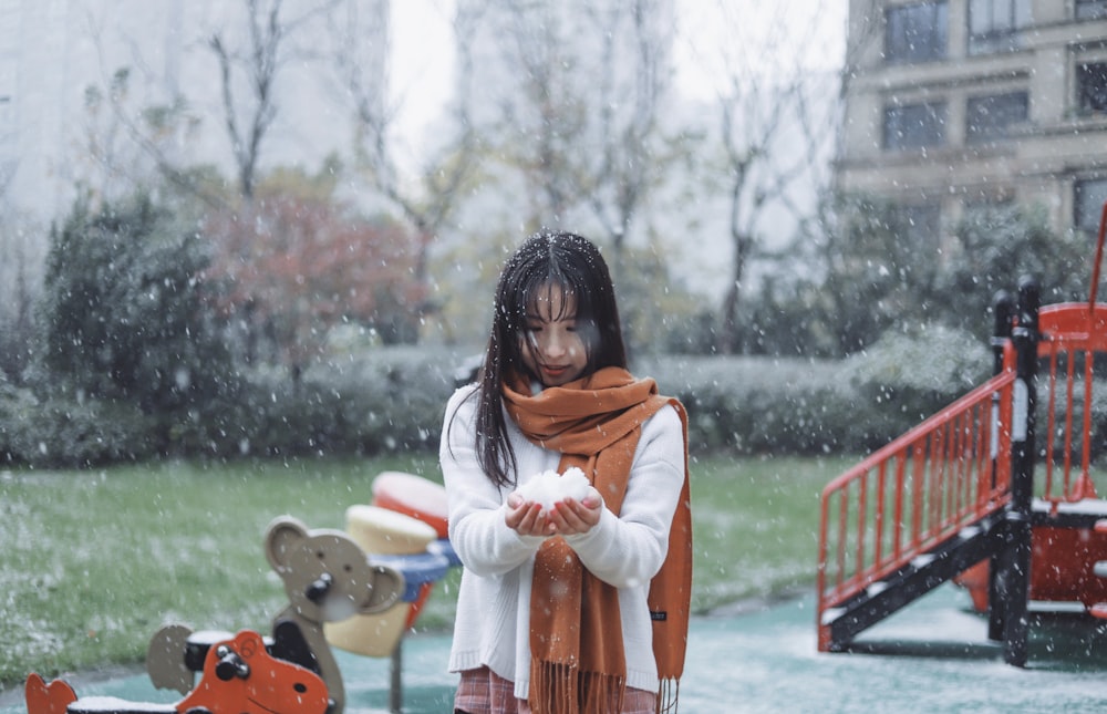 woman standing while wearing brown scarf