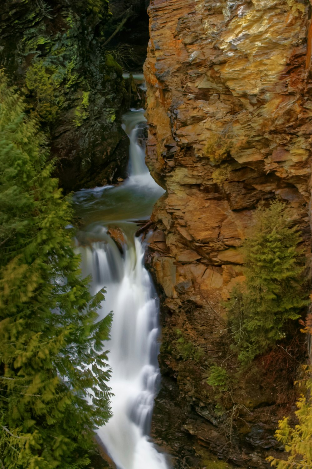 waterfalls beside rock formation
