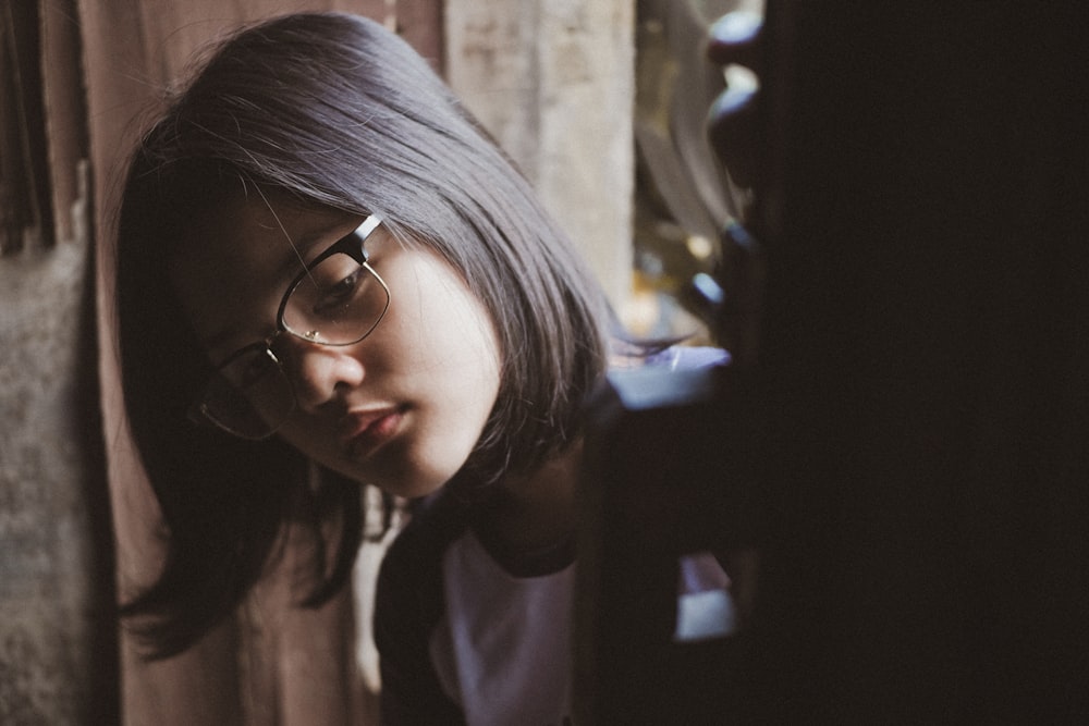 girl wearing eyeglasses in room